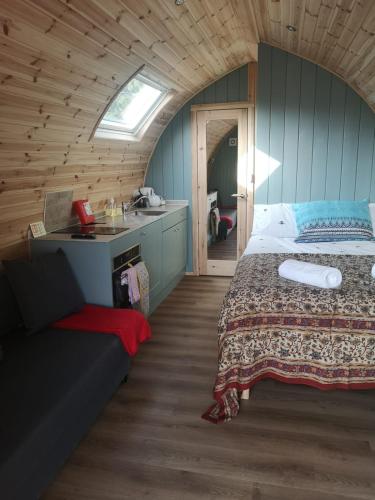 a bedroom with a bed and a sink in a room at Missin' Link Glamping in West Hoathley