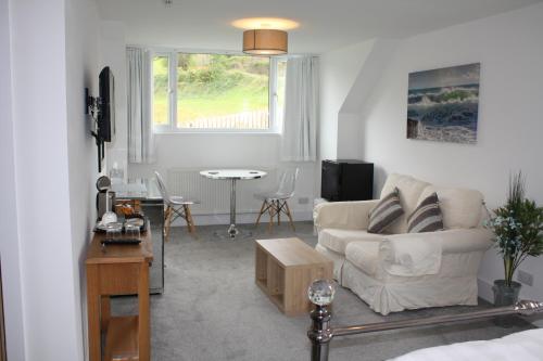 a living room with a couch and a table at Kerryanna Country House Bed and Breakfast in Mevagissey