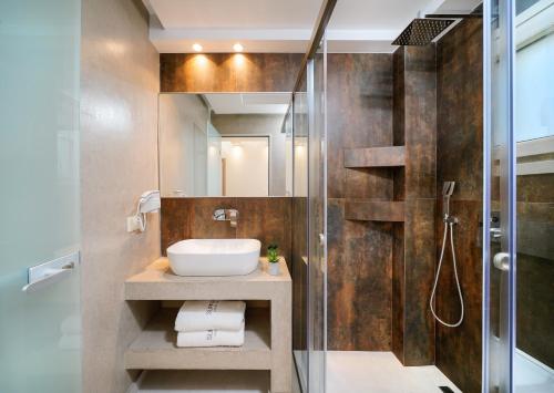 a bathroom with a sink and a shower at Supreme Luxury Suites in Skala Potamias