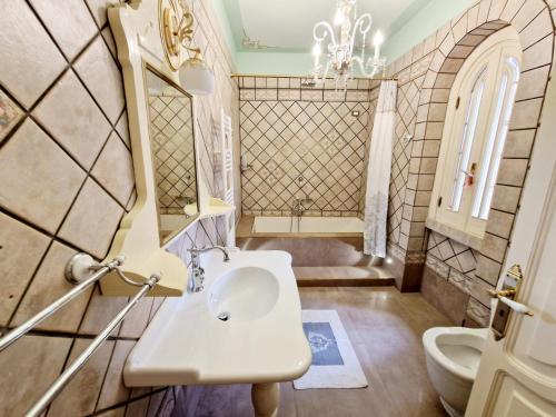 a bathroom with a sink and a toilet at Villa Full'House in Racale