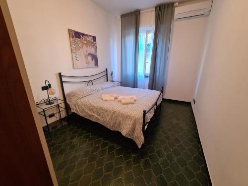 a bedroom with a bed with two towels on it at Casa Della Paola by PortofinoVacanze in Santa Margherita Ligure
