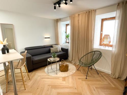 a living room with a couch and a table at Ferienwohnung Ava No2- Heiligkreuztal 1-2 Personen in Heiligkreuztal