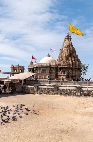 a building with a yellow flag on top of it at Dwarkadhish Lords Eco Inn in Dwarka