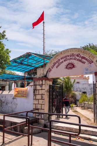 a building with a red flag on top of it at Dwarkadhish Lords Eco Inn in Dwarka