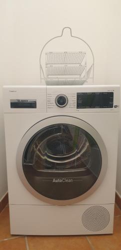 a white washing machine with a basket on top at Giulia's House in Galatina