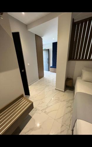 a large room with a bed and a hallway at V luxury Suites in Pefkohori