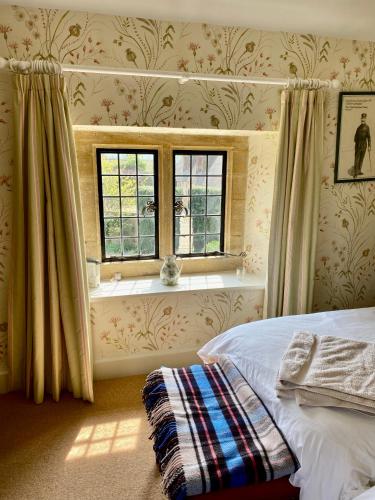 a bedroom with a bed and a window at The Grange in North Cadbury