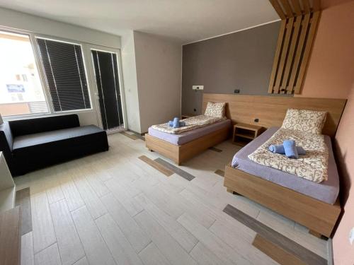 a large room with two beds and a couch at Siesta Srebrno Jezero in Veliko Gradište