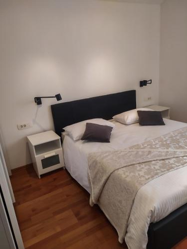 a bedroom with two twin beds and a night stand at Apartman Diana in Labin