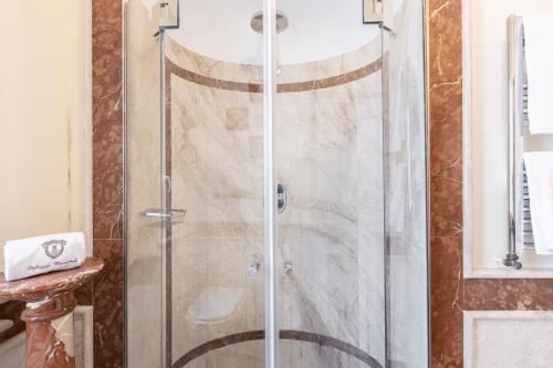 a shower with a glass door in a bathroom at Palazzo Marziale in Sorrento