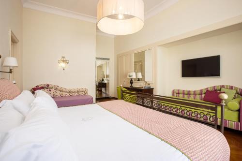 a hotel room with a bed and a tv at Palazzo Marziale in Sorrento