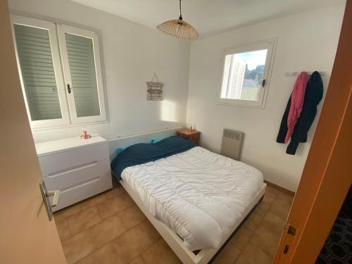 a bedroom with a bed and a sink and two windows at petit paradis pres ile rousse gîte les cortalines Lama in Lama