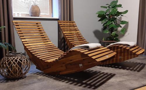 two wooden chairs are sitting in a room at Penzion a Restaurace v Zátiší in Horní Lhota