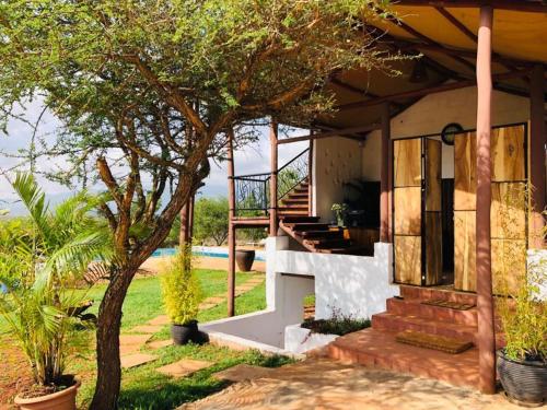 a house with a view of the yard at Oldonyo Orok Lodge in Kajiado