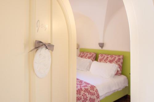 a bedroom with a bed with a bow on it at Palazzo Marziale in Sorrento