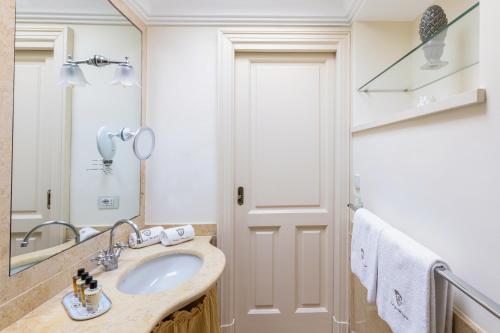 a bathroom with a sink and a mirror at Palazzo Marziale in Sorrento