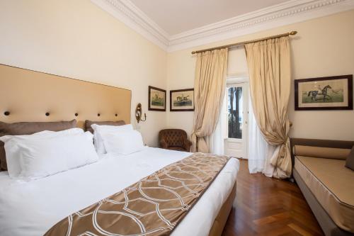 a bedroom with a large bed and a couch at Palazzo Marziale in Sorrento