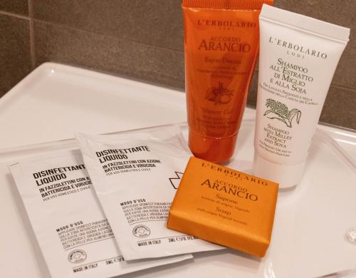 a couple of products sitting on top of a sink at V Hotel in Ancona
