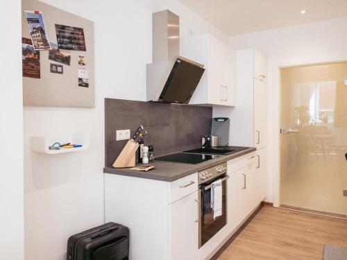 a small kitchen with a sink and a stove at Brunnen Apartments in Nürnberg