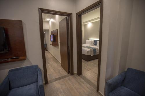 a hotel room with a mirror and a bedroom at Stay Inn Cairo Hotel in Cairo