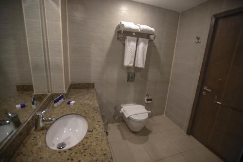 a bathroom with a sink and a toilet at Stay Inn Cairo Hotel in Cairo