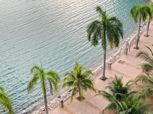 an aerial view of a beach with palm trees at BayView Suites Port Dickson By MAISON in Port Dickson