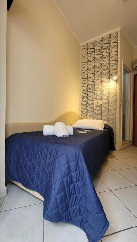 a bedroom with a blue bed with towels on it at Hotel Adigrat in Riccione