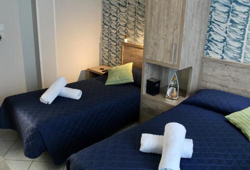 a bedroom with two beds with towels on them at Hotel Adigrat in Riccione