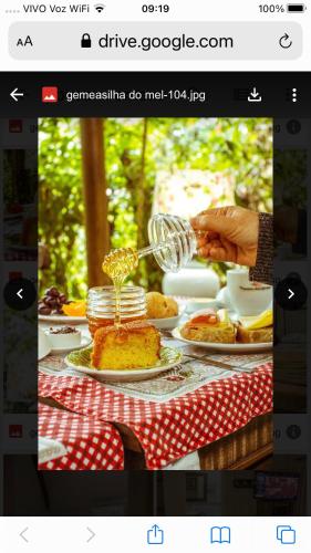 a person is making a cake on a table at Pousada das Gêmeas in Ilha do Mel