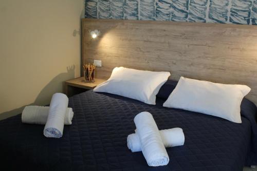 a bedroom with a bed with white pillows at Hotel Adigrat in Riccione