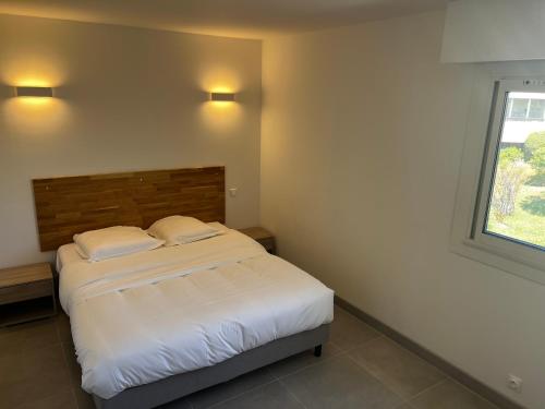 Ένα ή περισσότερα κρεβάτια σε δωμάτιο στο Appartements résidence Harmonie vue mer