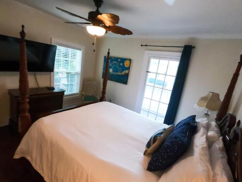 a bedroom with a white bed and a ceiling fan at Villa Mulvey # 4 in Saint Augustine