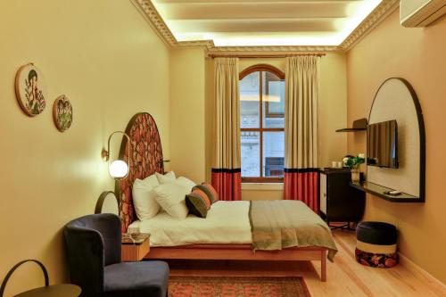 a bedroom with a bed and a window at Sirin Han Hotel Old City in Istanbul