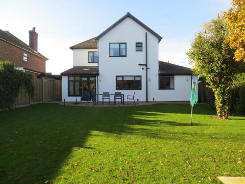 a house with a lawn in front of it at Seaside Retreat in Hunstanton