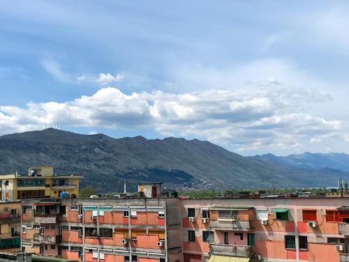 a group of buildings with mountains in the background at Diti's Apartment in Shkodër