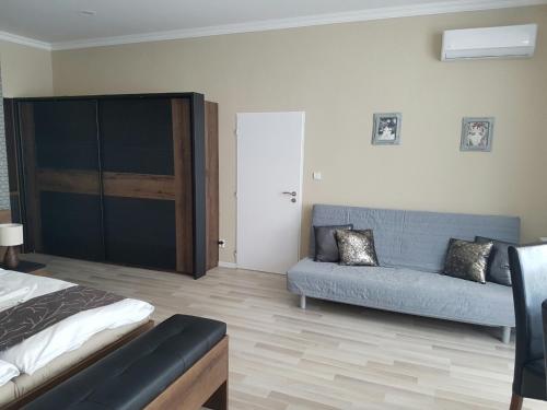 a living room with a couch and a bed at Ubytování Cukrovar in Lovosice