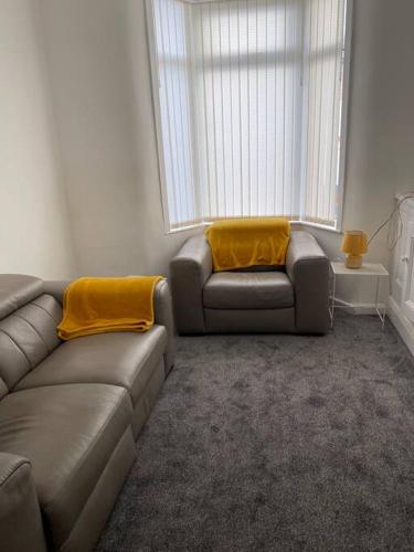 a living room with a couch and a chair at Modern 2 bed sleep 5 close to Anfield Stadium in Liverpool