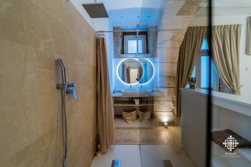 La salle de bains est pourvue d'un lavabo et d'un miroir. dans l'établissement Casa Tal - Exclusive home in Ortigia, à Syracuse