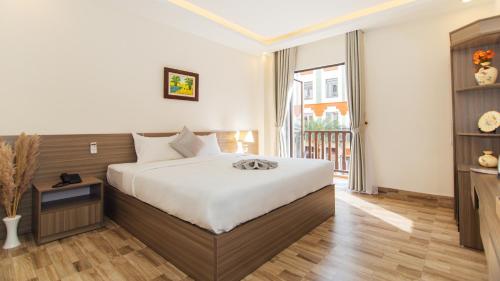 a hotel room with a bed and a balcony at Green bay hotel Ha Long in Ha Long