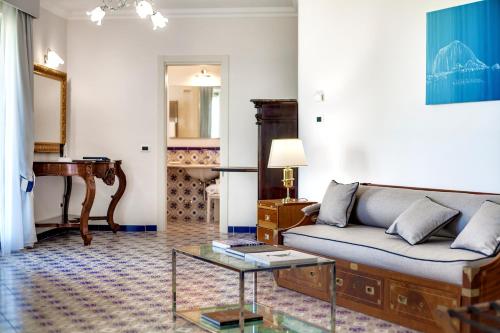 a living room with a couch and a table at San Montano Resort & Spa in Ischia