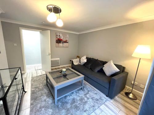 a living room with a couch and a table at Superb 2 Bed Apartment in Finnieston, Close to SEC, Hydro and City Centre in Glasgow
