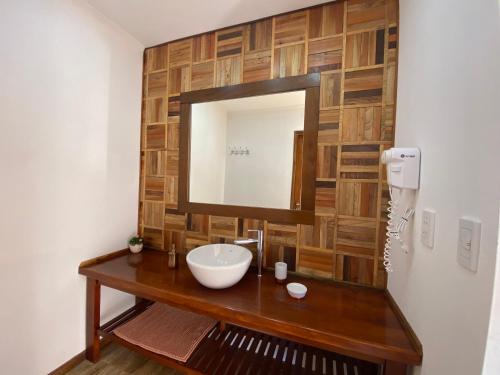 a bathroom with a sink and a mirror at Patagonia Austral Suites in El Calafate