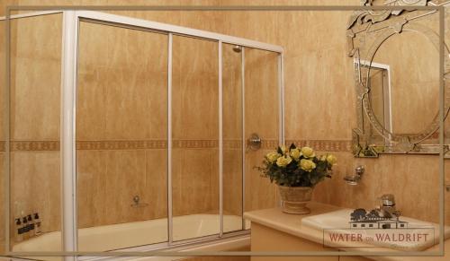 a bathroom with a shower and a sink at Water on Waldrift Guesthouse in Vereeniging