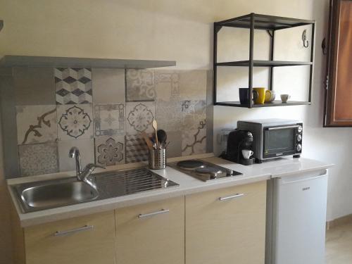 a kitchen with a sink and a microwave at Colle d'Elce in Deliceto