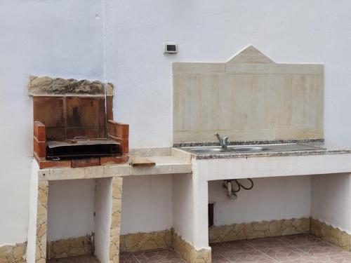 a kitchen with a sink and a counter top at Villa Melania ( Delfino BLU) in Lampedusa