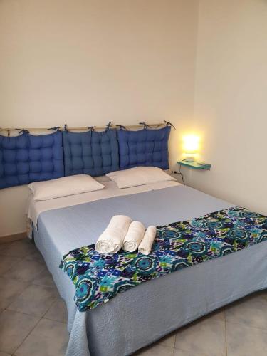 a bedroom with a bed with two towels on it at Villa Melania ( Delfino BLU) in Lampedusa