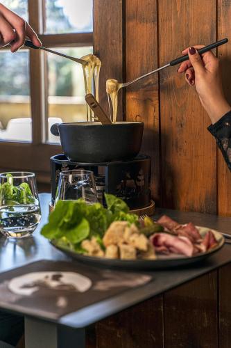 a plate of food on a table with a plate of food at La Ferme du Golf in Megève