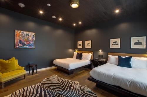 a room with two beds and a zebra print rug at Venice V Hotel in Los Angeles