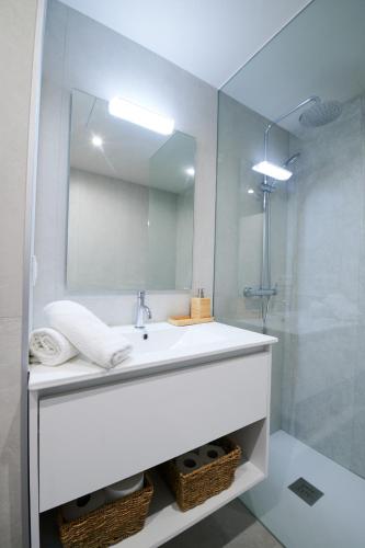 a bathroom with a white sink and a mirror at Costa Brava E-4 in Calella de Palafrugell