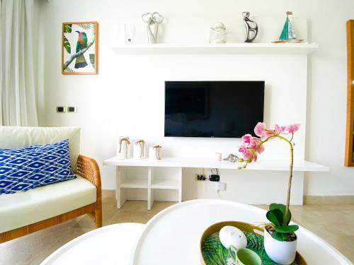 a living room with a couch and a table at Xeliter Cana Rock Punta Cana in Punta Cana